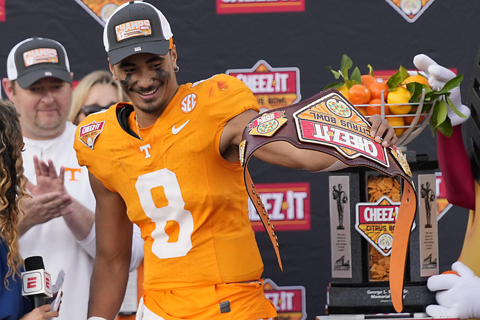 Tennessee quarterback Nico Iamaleava shows his MVP belt to teammates after defeating Iowa in the Citrus Bowl NCAA college football game, Monday, Jan. 1, 2024, in Orlando, Fla. (AP Photo/John Raoux)