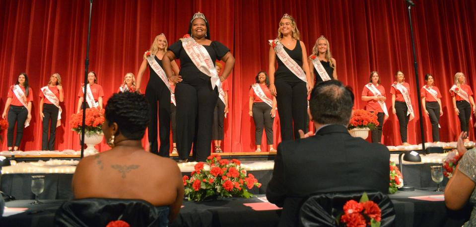The 2022 Greater Alliance Carnation Festival queen and court stand front and center at the start of the 2023 Greater Alliance Carnation Festival Pageant Saturday, July 29, 2023, in the Alliance High School auditorium.