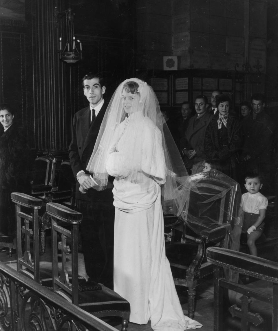 Full-length portrait of French actor Brigitte Bardot and her husband, French director Roger Vadim standing at the altar during their wedding ceremony at the Church of Passy, Paris.