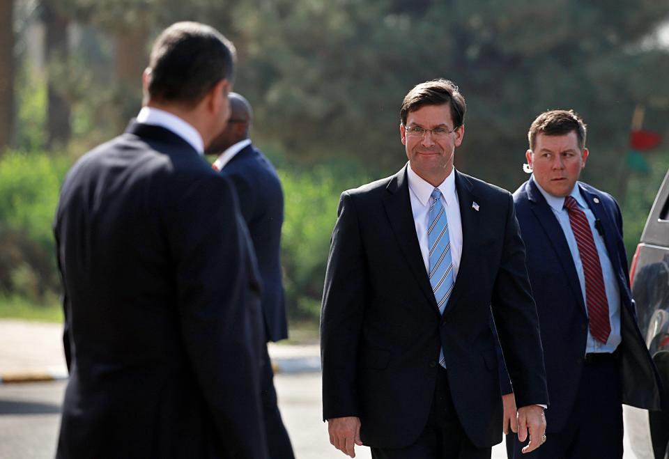 Iraqi Defense Minister Najah al-Shammari, left, prepares to welcome the visiting U.S. Defense Secretary Mark Esper, center right, at the Ministry of Defense, Baghdad, Iraq, Wednesday, Oct. 23, 2019. Esper has arrived in Baghdad on a visit aimed at working out details about the future of American troops that are withdrawing from Syria to neighboring Iraq. (AP Photo/Hadi Mizban)