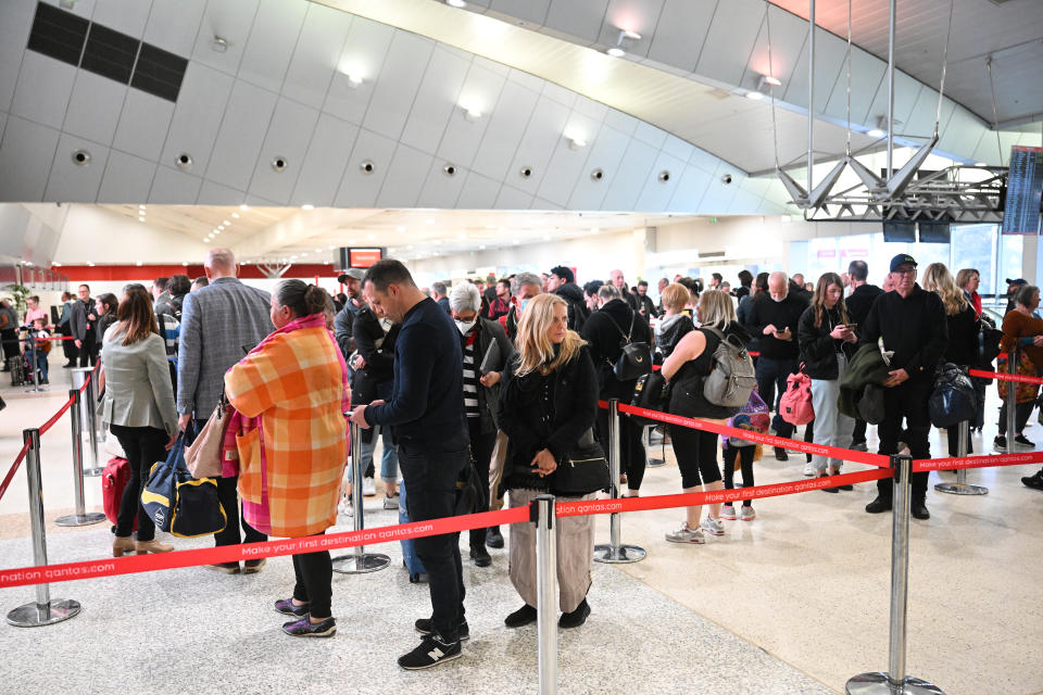 People are seen in line at the Qantas domestic arrivals terminal at Melbourne International Airport in Melbourne.