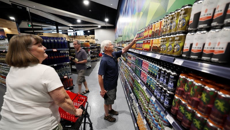 Debbie Wolf and Michael Wolf look at the wall of Utah-produced products at the new State Liquor Store in Sandy on Monday, July 31, 2023. Women face heightened risks of heart disease, liver disease and long-term negative health impacts from alcohol use.