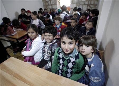 Syrian refugee children attend class at a school for refugee children in Istanbul October 21, 2013. REUTERS/Osman Orsal