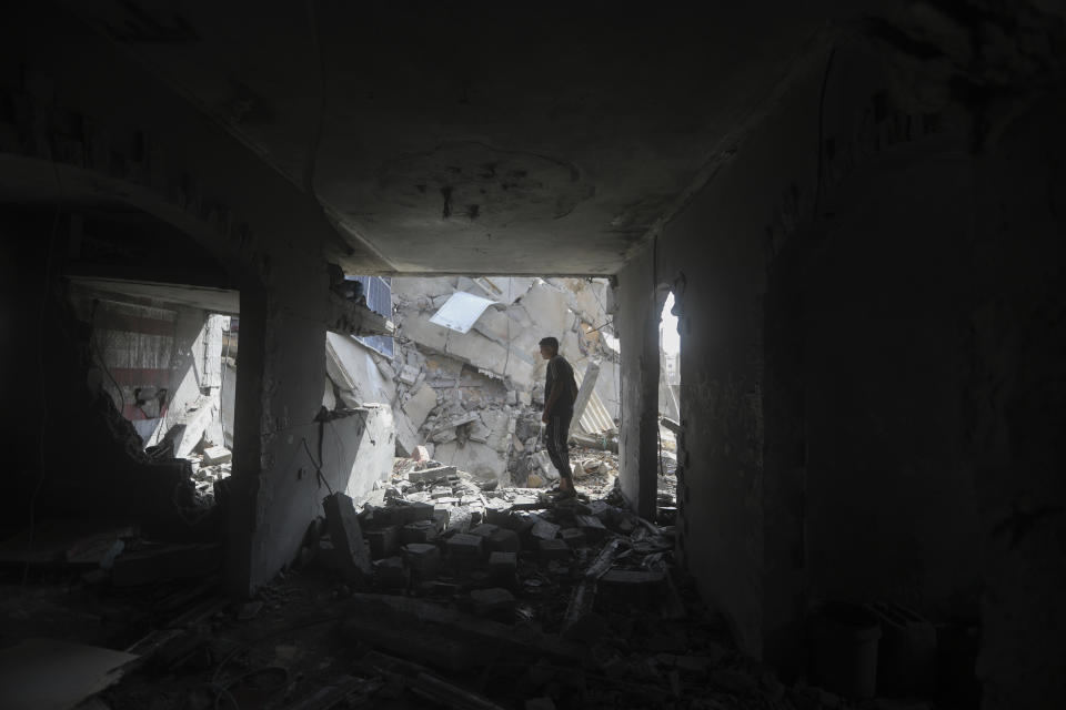 Palestinians look at the destruction after an Israeli strike on residential building in Rafah, Gaza Strip, Tuesday, May 7, 2024. (AP Photo/Ismael Abu Dayyah)