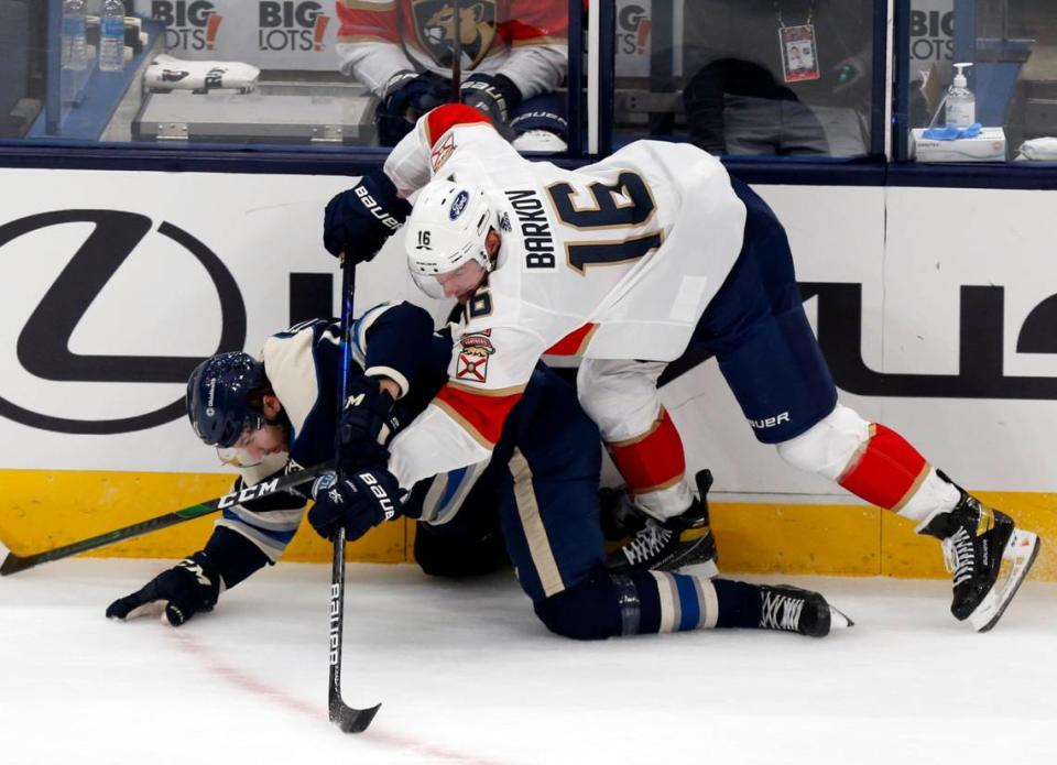 Florida Panthers forward Aleksander Barkov, top, of Finland, checks Columbus Blue Jackets forward Kevin Stenlund, of Sweden, during the first period of an NHL hockey game in Columbus, Ohio, Tuesday, Jan. 26, 2021. (AP Photo/Paul Vernon)