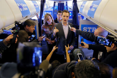 Robby Mook, Campaign Manager for U.S. Democratic presidential nominee Hillary Clinton, and Communications Director Jen Palmieri (L) talk to reporters onboard the campaign plane enroute to Cedar Rapids, Iowa, U.S. October 28, 2016. REUTERS/Brian Snyder