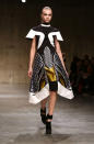 <b>LFW AW13: Peter Pilotto </b><br><br>Cara Delevingne modelled a monochrome frock with gold accents.<br><br>© Getty