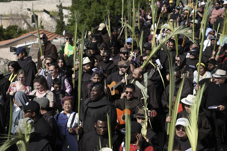 Christians walk in the Palm Sunday procession on the Mount of Olives in east Jerusalem, Sunday, April 2, 2023. The procession observes Jesus' entrance into Jerusalem in the time leading up to his crucifixion, which Christians mark on Good Friday. (AP Photo/Mahmoud Illean)