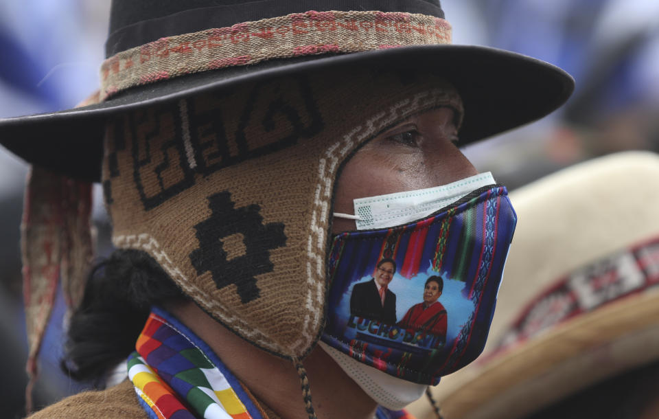 A supporter of Luis Arce, who is running for president for the Movement Towards Socialism Party, MAS, attends Arce's closing campaign rally in El Alto, Bolivia, Wednesday, Oct. 14, 2020. Elections will be held Oct. 18. (AP Photo/Juan Karita)