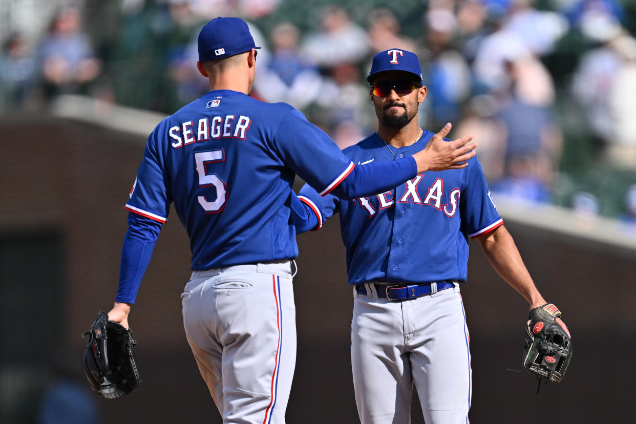 CHICAGO, IL - APRIL 09:  Corey Seager #5 and Marcus Semien #2 of the Texas Rangers congratulate each other after defeating the Chicago Cubs 8-2 at Wrigley Field on April 09, 2023 in Chicago, Illinois.  (Photo by Jamie Sabau/Getty Images)
