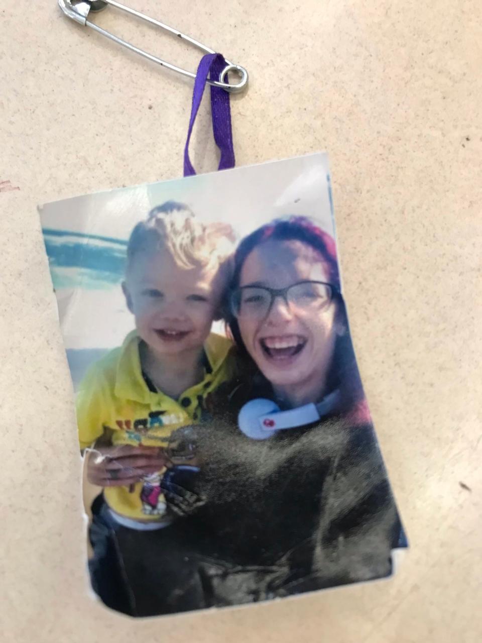 Tiny photographs of Karissa Fretwell beaming and holding her son, Billy, with purple ribbons attached to safety pins, were handed out at their July 7, 2019 celebration of life. Purple was Karissa’s favorite color.