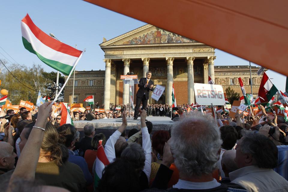 Hungarian Prime Minister and Chairman of ruling centre right Fidesz party Viktor Orban applauds the crowd as he addresses the election rally of Fidesz and its coalition ally Christian Democratic People’s Party in Heroes’ Square in Budapest, Hungary, Saturday, March 29, 2014. The parliamentary elections are held on April 6, 2014 in Hungary. (AP Photo/MTI, Zsolt Szigetvary)