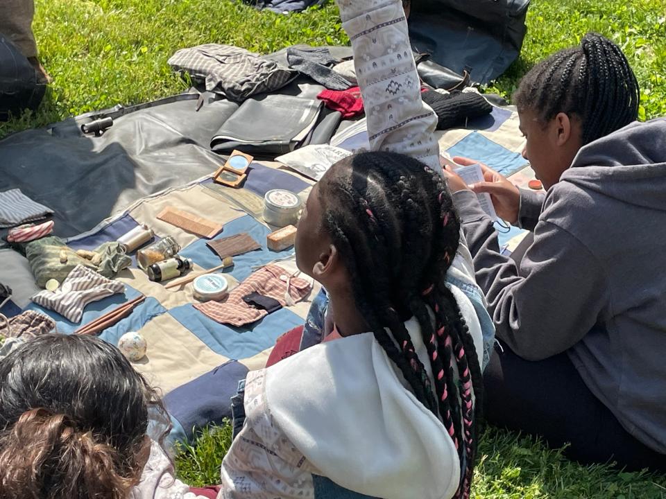 Students are allowed to examine and hold various artifacts provided by reenactors visiting Bester Elementary on Wednesday in Hagerstown.