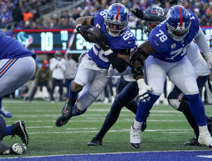 New York Giants running back Saquon Barkley (26) crosses the goal line for a touchdown against the Houston Texans during the third quarter of an NFL football game, Sunday, Nov. 13, 2022, in East Rutherford, N.J. (AP Photo/John Minchillo)