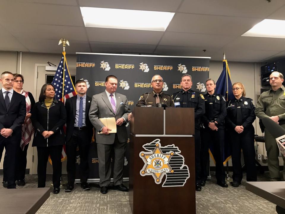 Macomb County Sheriff Anthony Wickersham, center, speaks about a prostitution and human trafficking investigation as he is flanked by other metro Detroit officials, including Macomb County Prosecutor Peter Lucido, in gray suit, during a news conference Dec. 18, 2023, at the county jail in Mount Clemens.