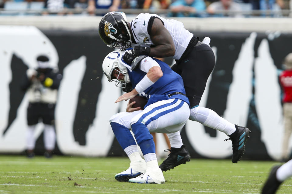 Jacksonville Jaguars linebacker Josh Allen (41) sacks Indianapolis Colts quarterback Matt Ryan (2) during the first half of an NFL football game, Sunday, Sept. 18, 2022, in Jacksonville, Fla. (AP Photo/Gary McCullough)