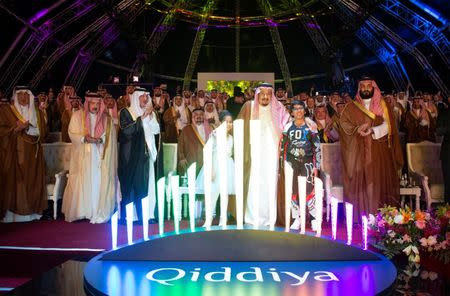 Saudi Arabia's King Salman bin Abdulaziz Al Saud (C) and Crown Prince Mohammed bin Salman (R) attend Qiddiya, multi-billion dollar entertainment resort, launching ceremony in Riyadh, Saudi Arabia April 28, 2018. Bandar Algaloud/Courtesy of Saudi Royal Court/Handout via REUTERS