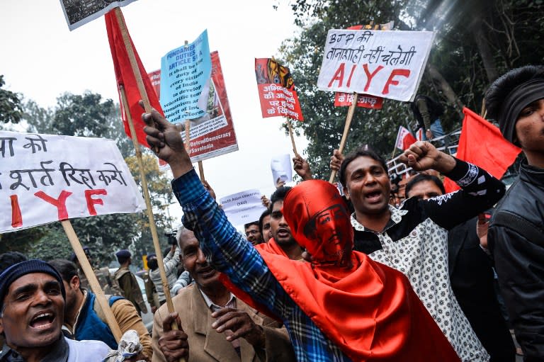 <p>An Indian student wears a mask with a photo of Bhagat Singh, an Indian revolutionary socialist who was influential in the Indian independence movement, as they shout slogans and protest against the arrest of an Indian student for sedition in New Delhi on February 18, 2016. Thousands of people rallied in New Delhi on February 18 to protest against the arrest of an Indian student for sedition, as a bitter row over freedom of speech spilled into the capital’s streets. </p>