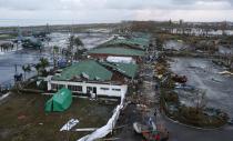 Philippine military C130 cargo planes (L) ferrying supplies park at the tarmac outside an airport after super Typhoon Haiyan battered Tacloban city in central Philippines November 9, 2013. Possibly the strongest typhoon ever to hit land devastated the central Philippine city of Tacloban, killing at least 100 people, turning houses into rubble and leveling the airport in a surge of flood water and high wind, officials said on Saturday. The toll of death and damage from Typhoon Haiyan on Friday is expected to rise sharply as rescue workers and soldiers reach areas cut off by the massive, fast-moving storm which weakened to a category 4 on Saturday. REUTERS/Erik De Castro (PHILIPPINES - Tags: DISASTER ENVIRONMENT TRANSPORT MILITARY)