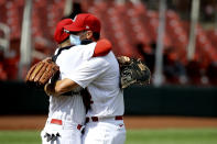 St. Louis Cardinals' Yadier Molina, left, celebrates with Adam Wainwright after Wainwright pitched nine complete innings against the Cleveland Indians, Sunday, Aug. 30, 2020, in St. Louis. (AP Photo/Scott Kane)