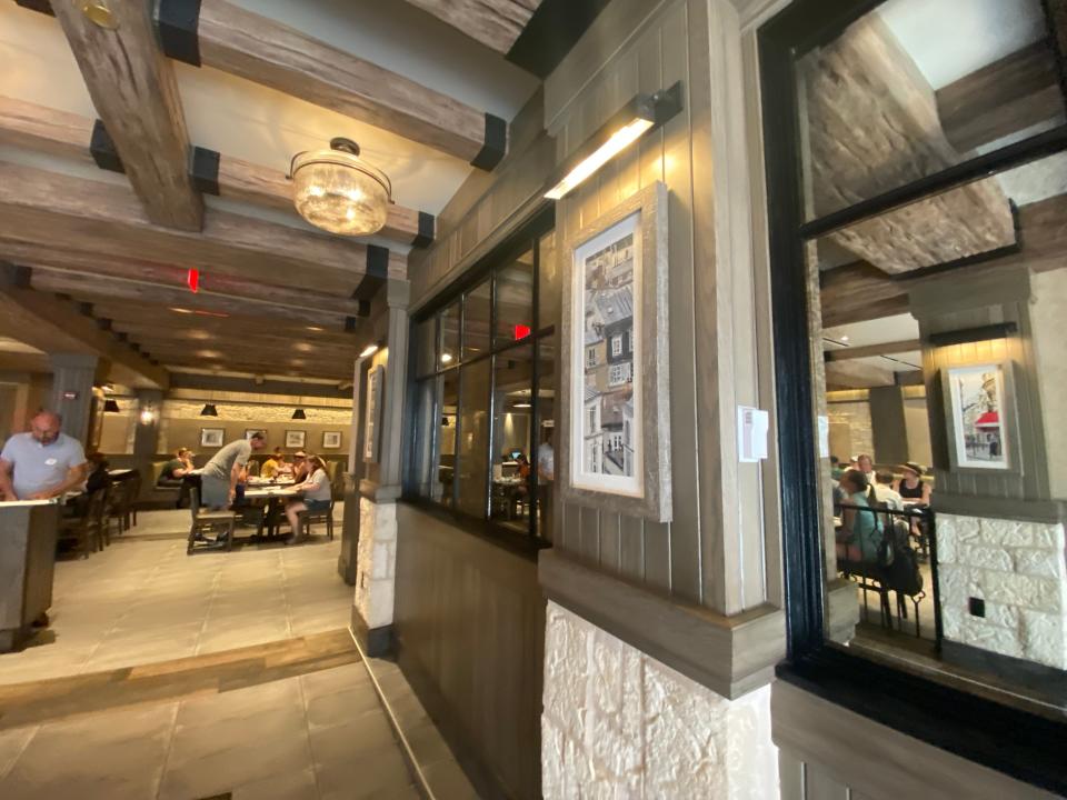 Interior view of le creperie de paris, with foyer area and wooden beams on ceiling