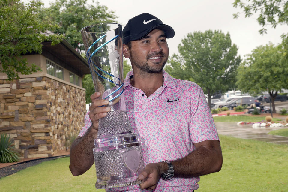 Jason Day, of Australia, poses for photos with the trophy after winning the Byron Nelson golf tournament in McKinney, Texas, Sunday, May 14, 2023. (AP Photo/LM Otero)