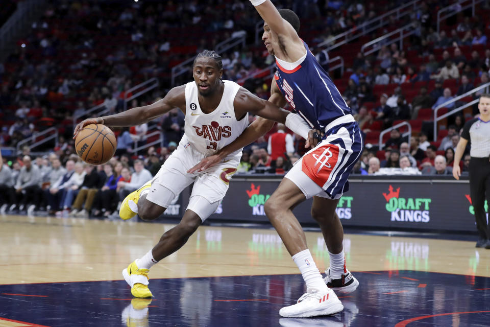 Cleveland Cavaliers guard Caris LeVert, left, drives around Houston Rockets forward Jabari Smith Jr. during the first half of an NBA basketball game Thursday, Jan. 26, 2023, in Houston. (AP Photo/Michael Wyke)