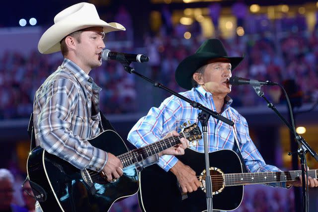 <p>Rick Diamond/Getty</p> George Strait and his son George "Bubba" Strait Jr. perform onstage at George Strait's 'The Cowboy Rides Away Tour' on June 7, 2014 in Arlington, Texas.