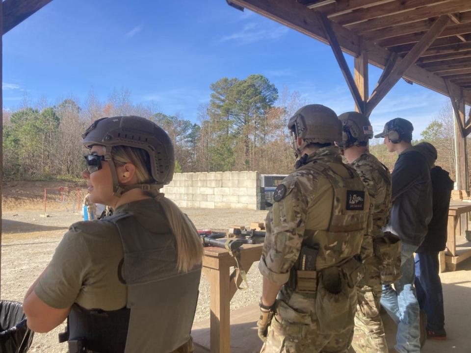 Former Olympic medalist Shawn Johnson watches celebrity competitors and Green Berets on Dec. 16, 2021, during the 2021 Tactical Challenge at the U.S. Army John F. Kennedy Special Warfare Center and School's Miller Training Complex at Fort Bragg.