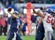 Oct 23, 2016; London, ENG; quarterback Case Keenum (17) of the Los Angeles Rams is put under pressure by linebacker Deontae Skinner (54) of the New York Giants as he looks to pass during the third quarter of the game between the Los Angeles Rams and the New York Giants at Twickenham Stadium. Mandatory Credit: Steve Flynn-USA TODAY Sports