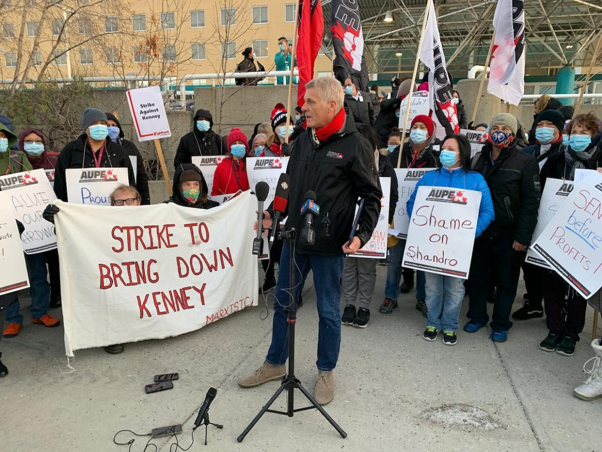 President of the Alberta Union of Provincial Employees, Guy Smith, stands amid striking workers outside Edmonton's Royal Alexandra Hospital during an illegal walkout. Labour watchers say there is the potential for widespread unrest and service disruption in Alberta in 2024 with so many public sector contracts expiring.  (David Bajer/CBC - image credit)