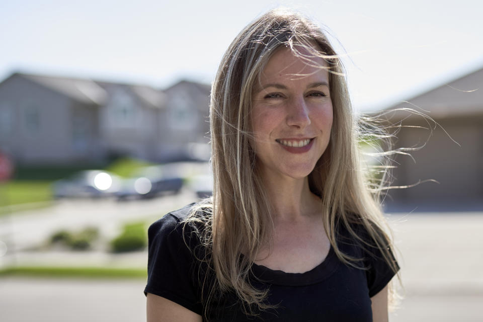 Tara Carlson poses for a photo outside her home in Omaha, Neb., Tuesday, July 7, 2020. Carlson pulled her kids out of summer camp at the last minute, losing $300 in deposits. (AP Photo/Nati Harnik)