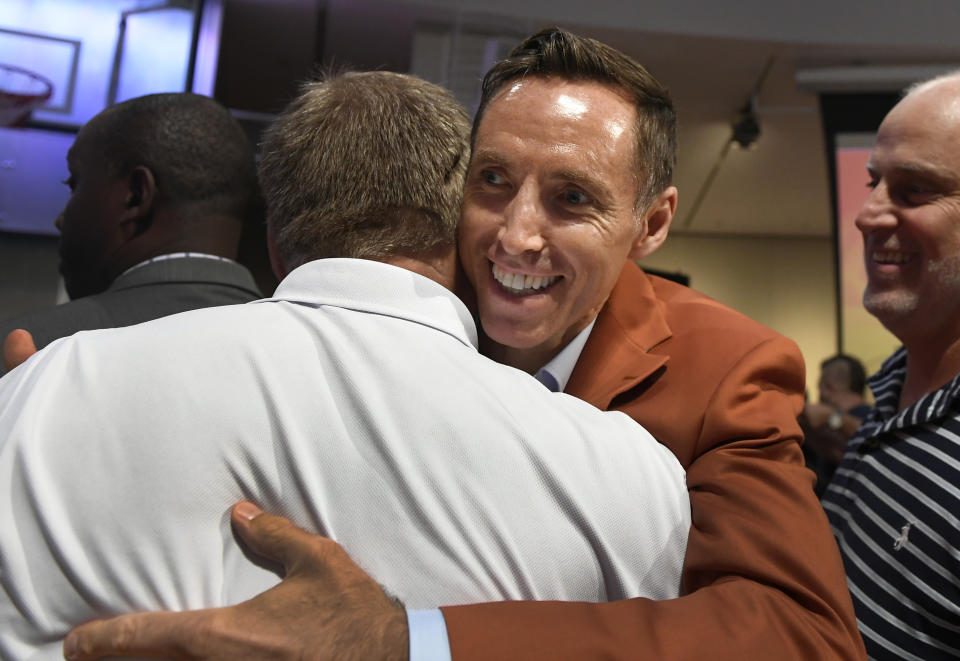 Steve Nash, a class of 2018 inductee into the Basketball Hall of Fame, hugs fans after a news conference at the Naismith Memorial Basketball Hall of Fame, Thursday, Sept. 6, 2018, in Springfield, Mass. (AP Photo/Jessica Hill)