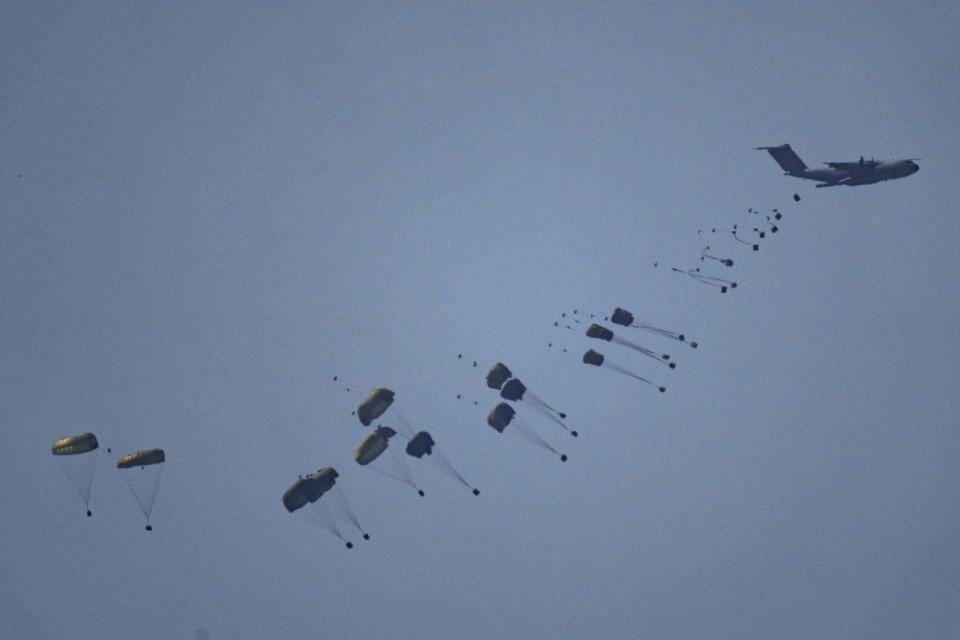 An aircraft airdrops humanitarian aid over Gaza the northern Gaza Strip, as seen from southern Israel, Friday, March 8, 2024. (AP Photo/Leo Correa)