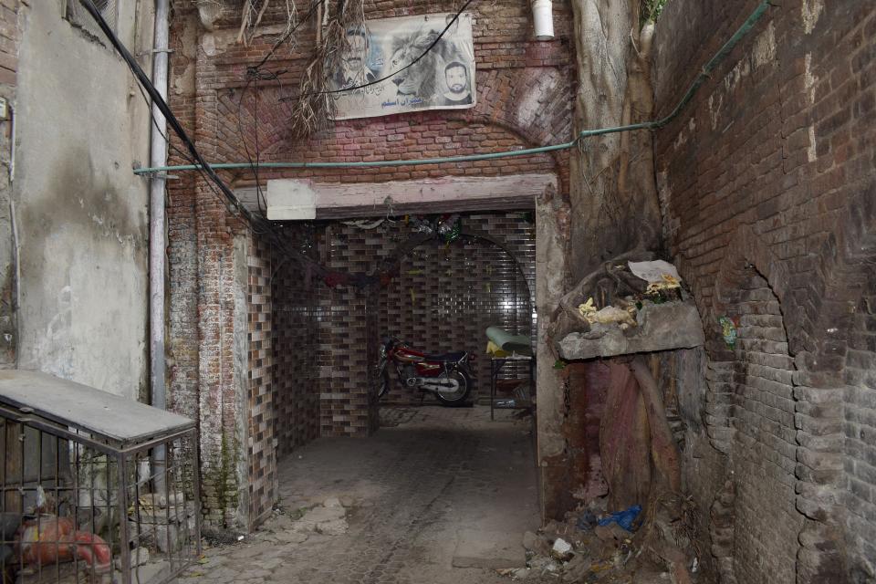 A motorbike is parked in a narrow alley of Machli Bazar area, where Britain's new prime minister Rishi Sunak's paternal grandfather Ramdas Sunak reportedly lived, in Gujranwala, Pakistan, Wednesday, Oct. 26, 2022. Britain's new prime minister, Rishi Sunak, has embraced his Indian and Hindu heritage but he also has roots in present-day Pakistan, in the industrial city of Gujranwala in the country's eastern Punjab province, where his paternal grandfather reportedly lived until 1935 during Britain's colonial rule. (AP Photo/Aftab Rizvi)
