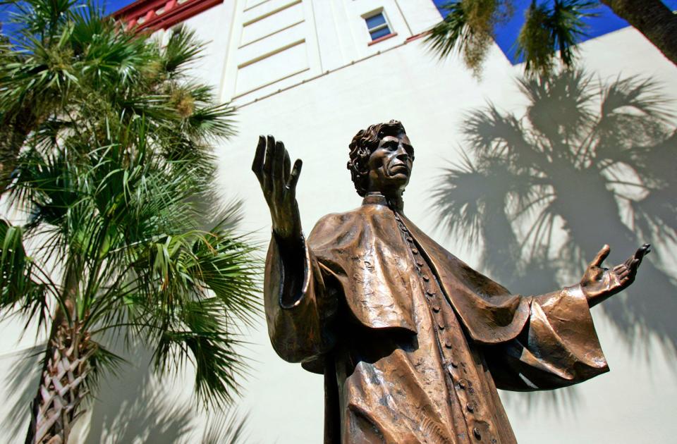 A bronze statue of Father Felix Varela stands in a courtyard in between the Cathedral Basilica.