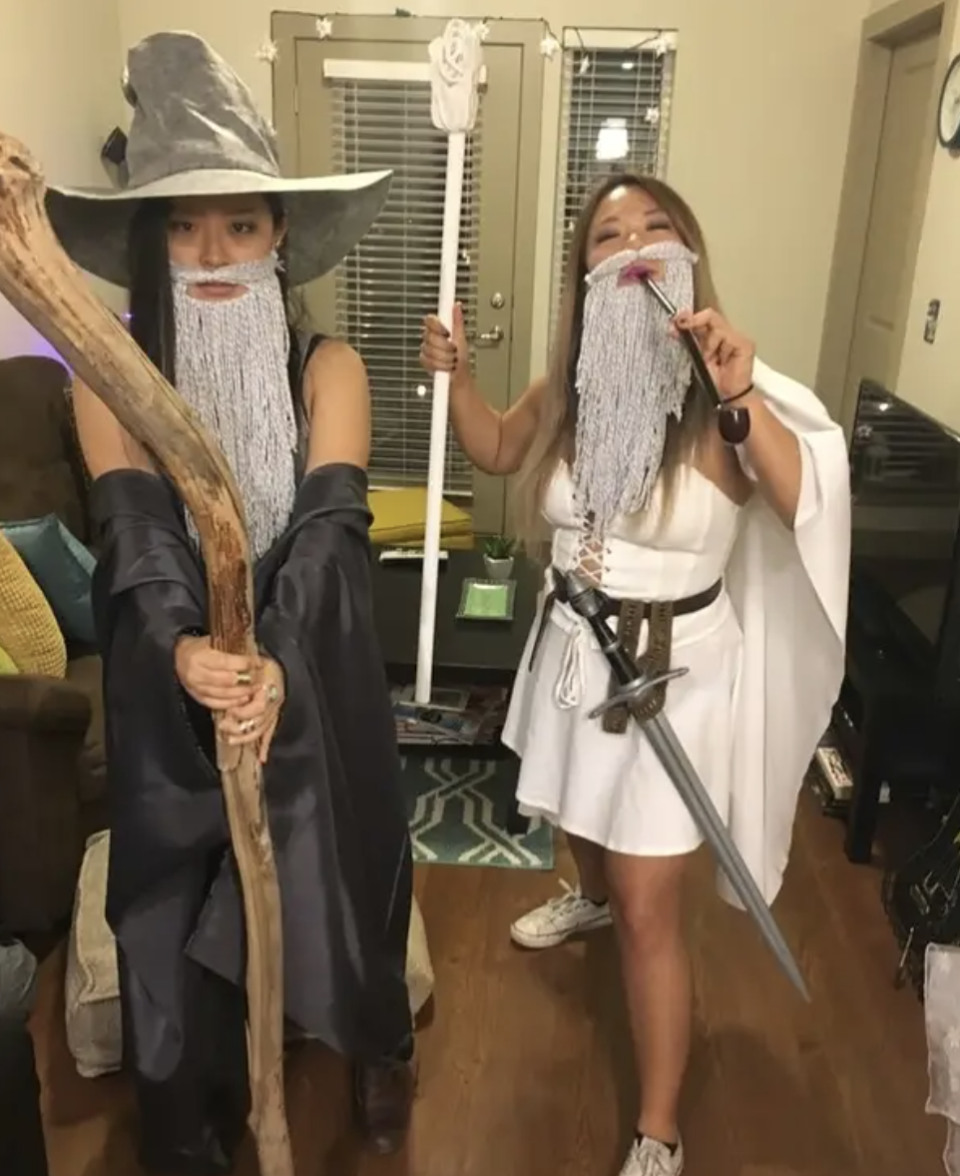 Two woman dressed as scantily-clad Gandalfs