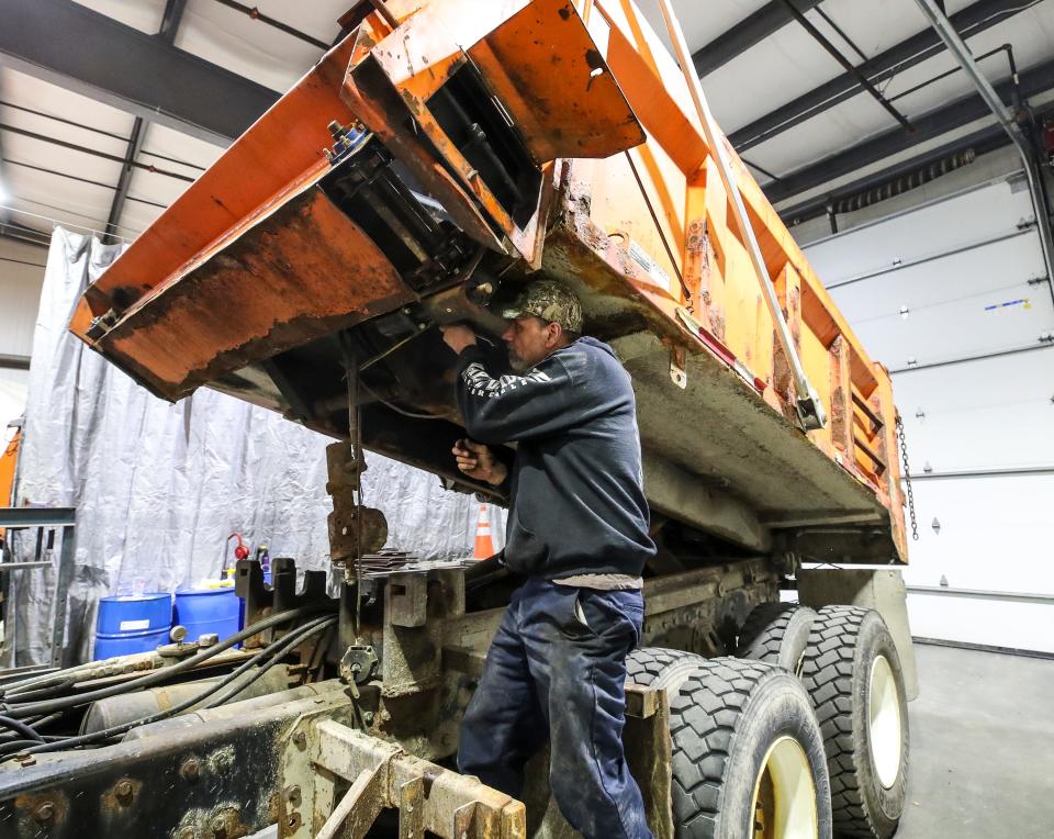 Todd Evans, with Louisville Metro Public Works, services a truck used to spread salt on local roads on December 21, 2022