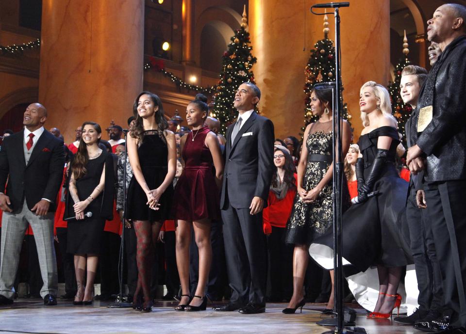 The Obama family participate in a song at the end of the taping of the 'Christmas in Washington' television special in Washington