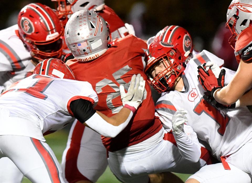 Canton South defenders Zanden Lewis and Tyler Pugh, right, try to stop Northwest wide receiver Connor Satterfield in the second quarter of Canton South at Northwest football. Friday, Oct. 20, 2023.