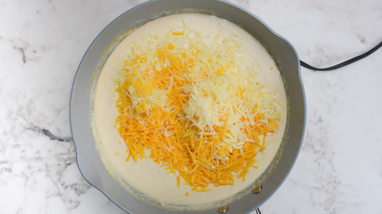 shredded cheese added to pan