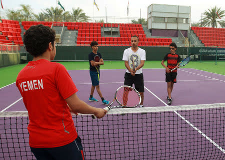 Suhail Alsaeedi from Sanaa, Ammar Saeed from Aden, Alhassan Ishaq from Sanaa and their coach Osama al-Maqaleh take part in a training session at Khalifa International Tennis and Squash Complex in Doha, Qatar, March 2, 2017. Picture taken March 2, 2017. REUTERS/Naseem Zeitoon