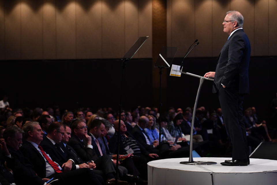 Prime Minister Scott Morrison speaks as former Treasurer Peter Costello (left) listens during the AFR summit in Sydney, Tuesday, March 10, 2020. (AAP Image/Dean Lewins)