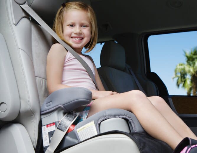 young girl in car booster seat