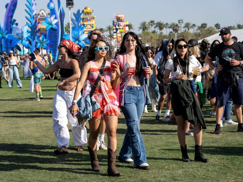 Group of women walk through Coachella wearing festival fashion