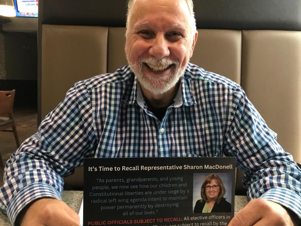 Dr. Michael Ross, of Troy, a Republican, on Oct. 26, 2023 shows off his campaign card for recalling state Rep. Sharon McDonell, D-Troy, at a restaurant on Rochester Road. Ross, who started the recall, said he canceled it in mid-October when he and volunteers could not gather enough signatures.