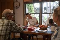 Meredith Ellis, center left, sits at the kitchen table next to her son, GC, 6, mother Mary, right, and father, also named, GC, at their ranch in Rosston, Texas, Thursday, April 20, 2023. Ellis' parents built this ranch and it's where she was raised, roaming with her brother through the pastures, creeks and hardwood forests as the family added land and cattle over the years. But now it's Ellis' turn to make the decisions, and she takes over at a time when the beef industry faces questions around every corner – how to increase cattle prices as inflation soars, if herd numbers need to be reduced amid long-term drought and most importantly, whether cattle can coexist with efforts to reduce heat-trapping greenhouse gases. (AP Photo/David Goldman)