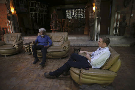 Nigerian Literature Nobel Laureate Wole Soyinka speaks to Reuters correspondent Tim Cocks (R) during an interview in Soyinka's home in the southwest city of Abeokuta July 1, 2014. Nigeria is suffering greater carnage at the hands of Islamist group Boko Haram than it did during a secessionist civil war, yet this has ironically made the country's break-up less likely, Soyinka said. REUTERS/Akintunde Akinleye