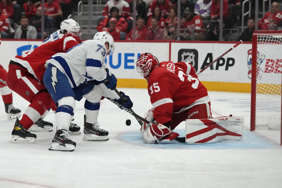 Detroit Red Wings goaltender Ville Husso (35) deflects a shot by Tampa Bay Lightning left wing Conor Sheary (73) during the first period of an NHL hockey game, Saturday, Oct. 14, 2023, in Detroit. (AP Photo/Carlos Osorio)