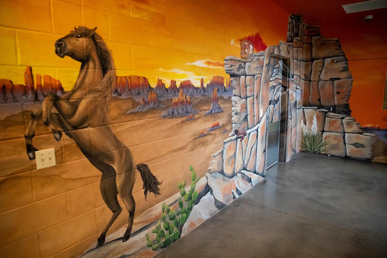 A western-themed mural created by artist Mary Minor and her team can be seen around the entrance to one of the courtyards where the children live within Bill’s Place at Youth Villages in Memphis, Tenn., on Friday, April 19, 2024. Murals throughout the facility are based on a road trip around the country and give information about each of the states.